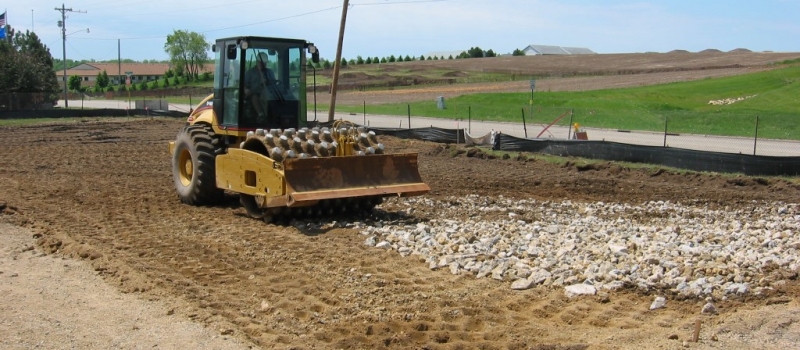 Excavation and Grading (7) photo of roller compacting large stone aggregate